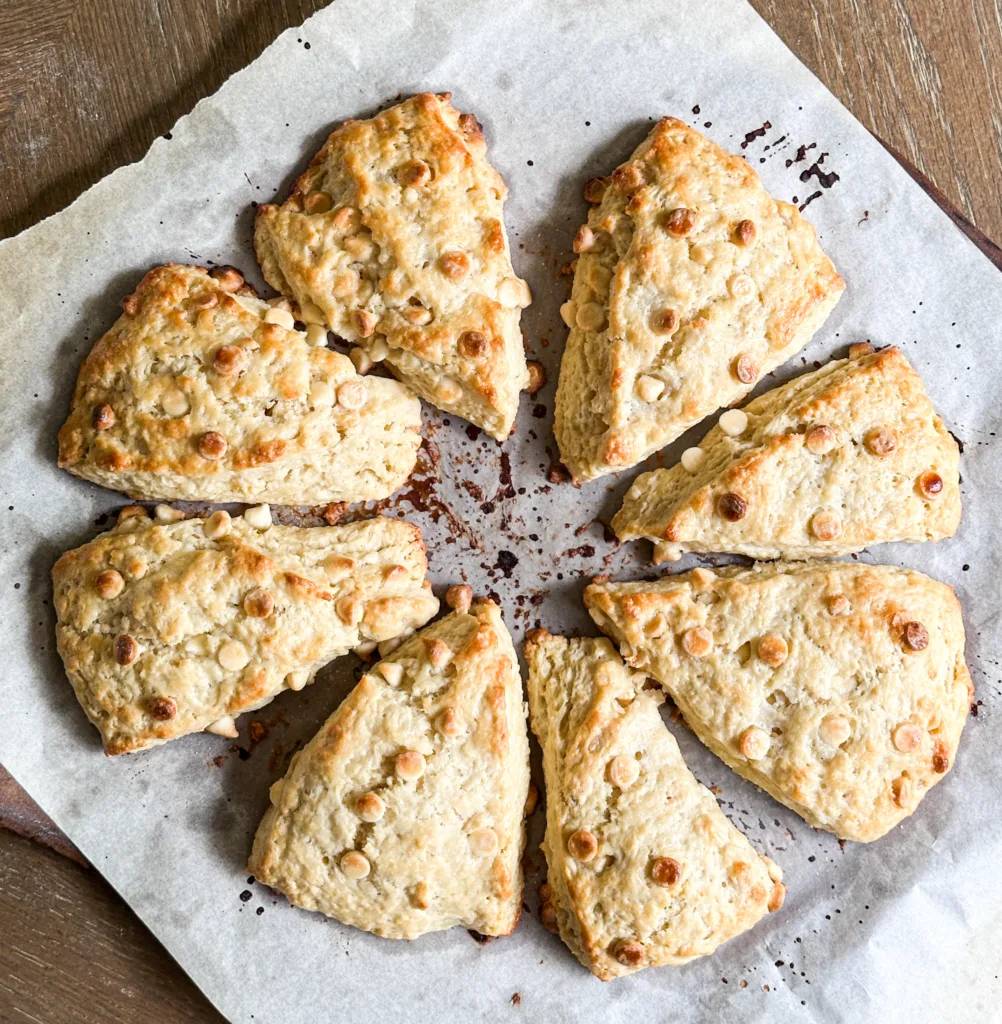 Sourdough scones with white chocolate and lemon freshly baked on a baking pan.