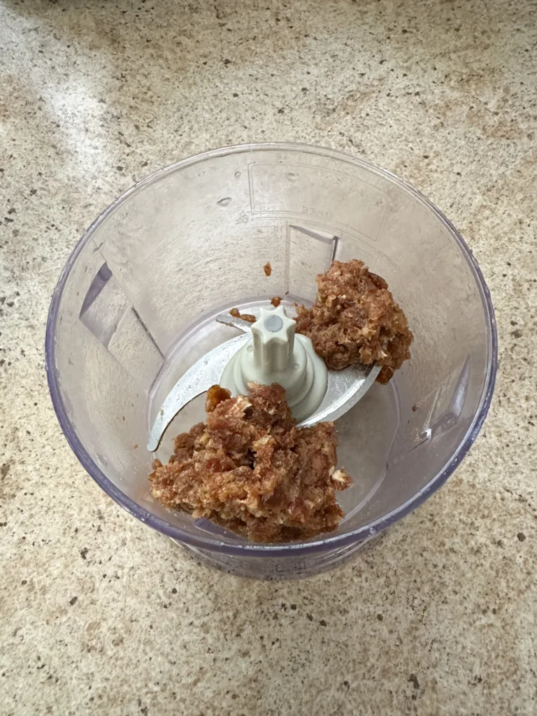 Dates chopped up inside of a food processor.