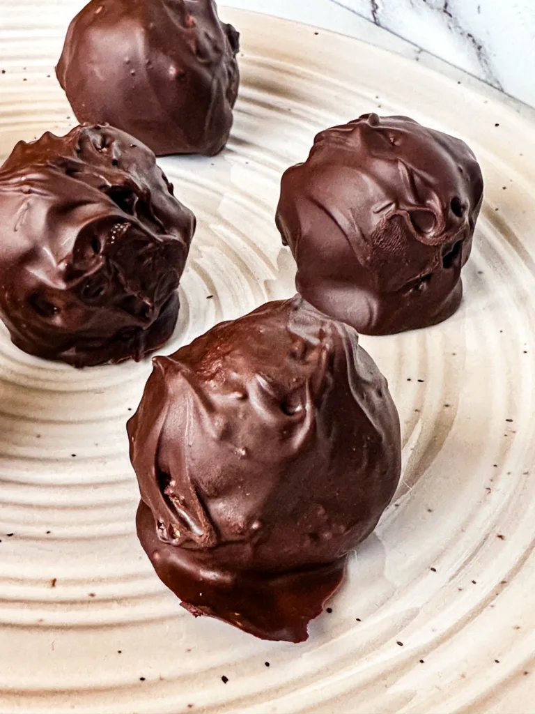 Chocolate date balls on a plate.