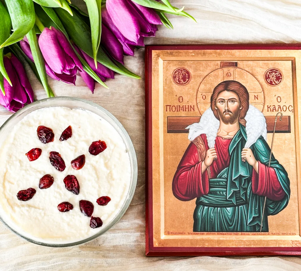 Cheese pascha with some tulips and an icon of Christ on a white tablecloth.
