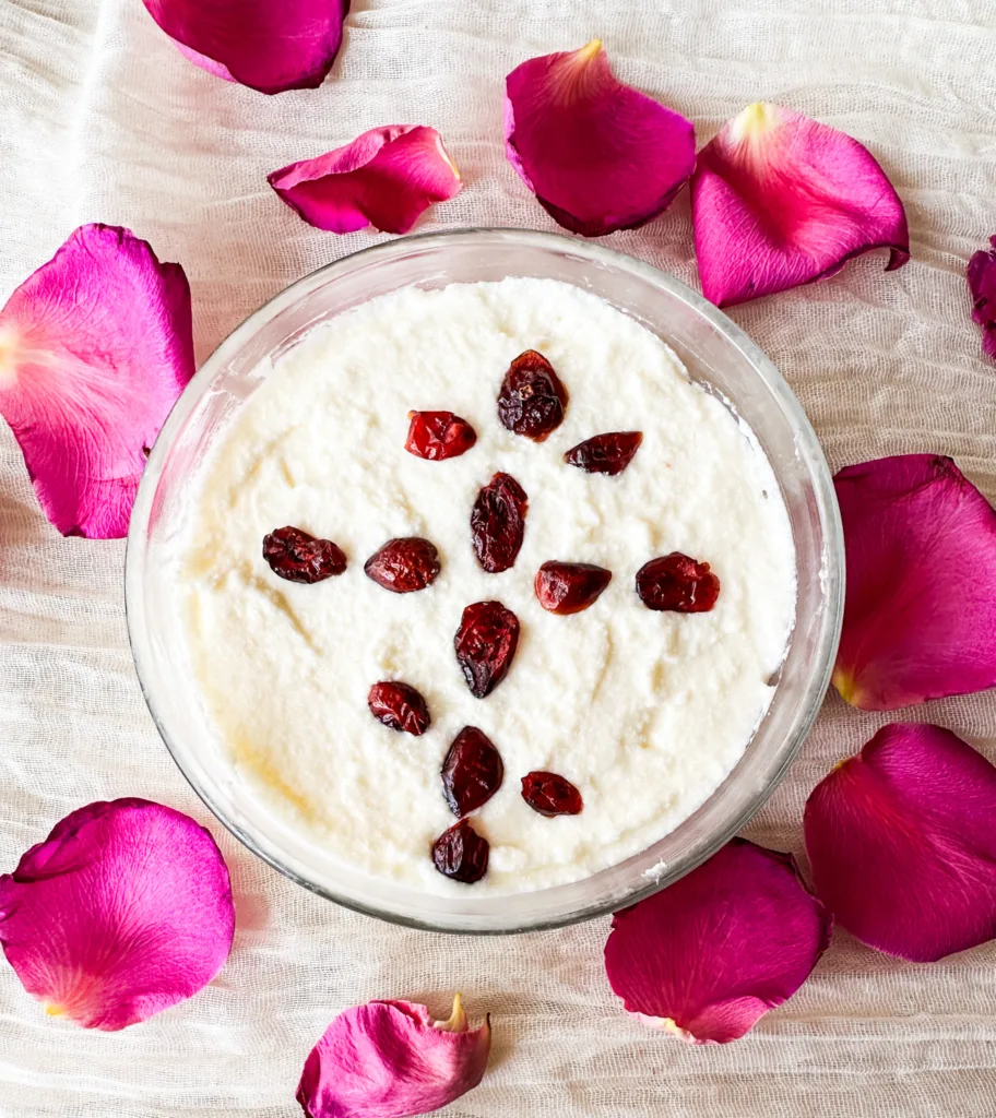 Cheese Pascha on top of a white table cloth and pink rose petals.