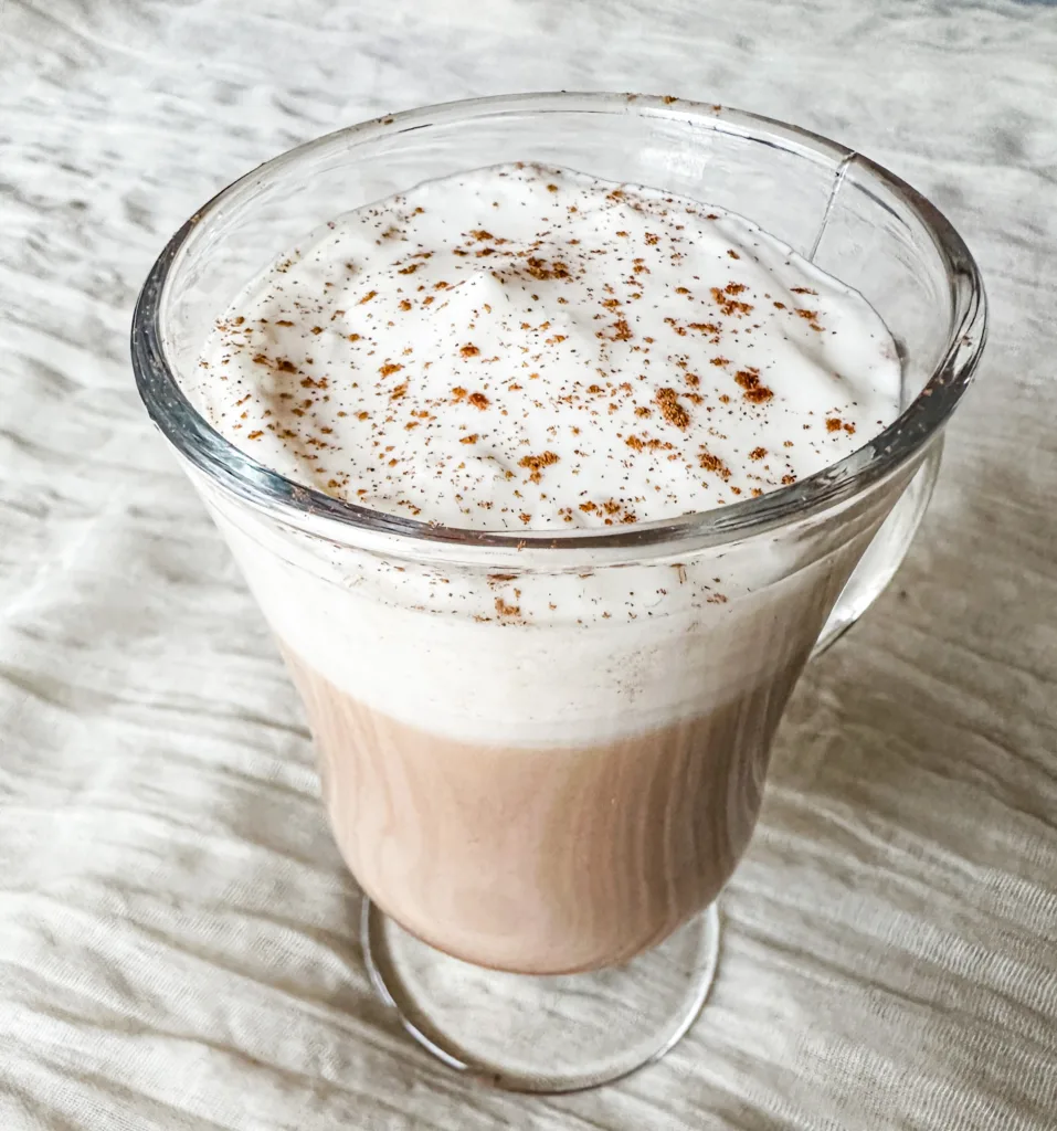 A latte with cold foam and cinnamon.