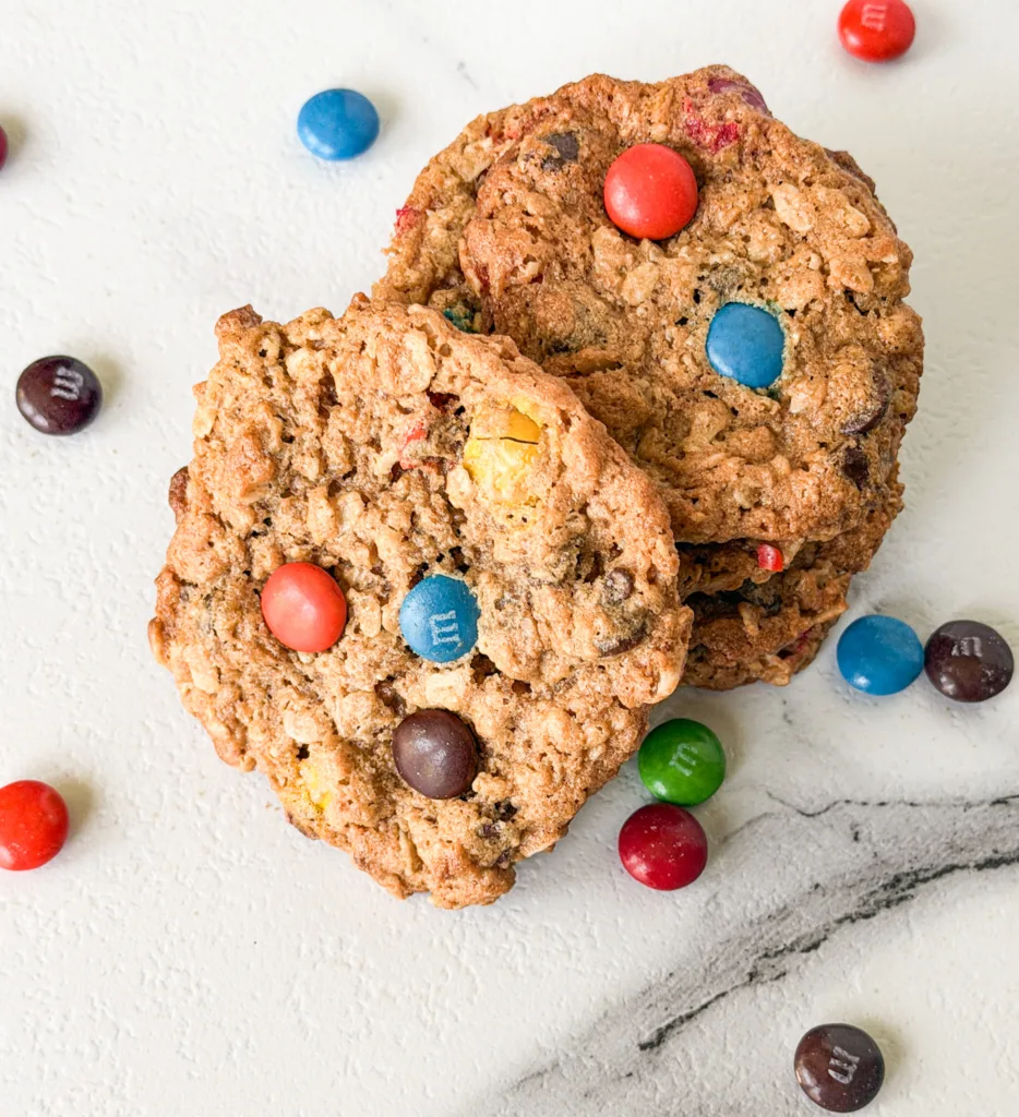 Einkorn monster cookies on a marble table with M&M's.