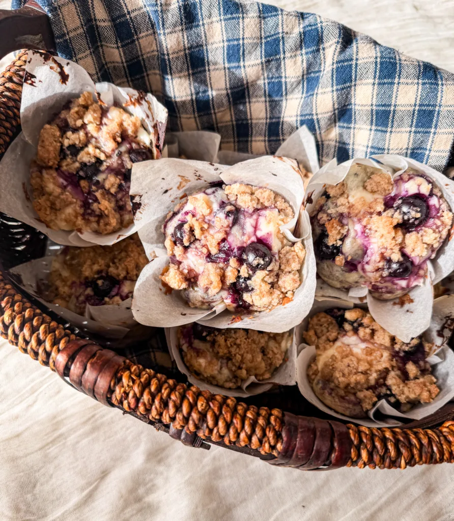Blueberry cream cheese muffins in a basket.
